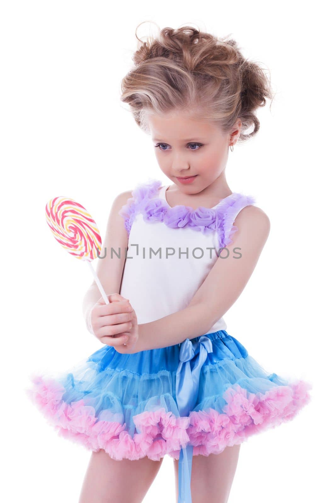Pretty little girl with lollipop. Isolated on white