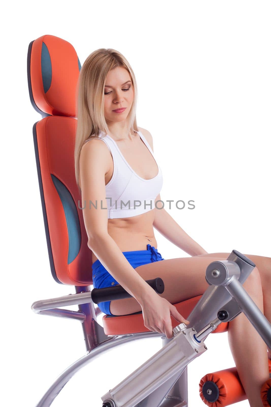 Young woman on isodynamic exerciser. Isolated on white