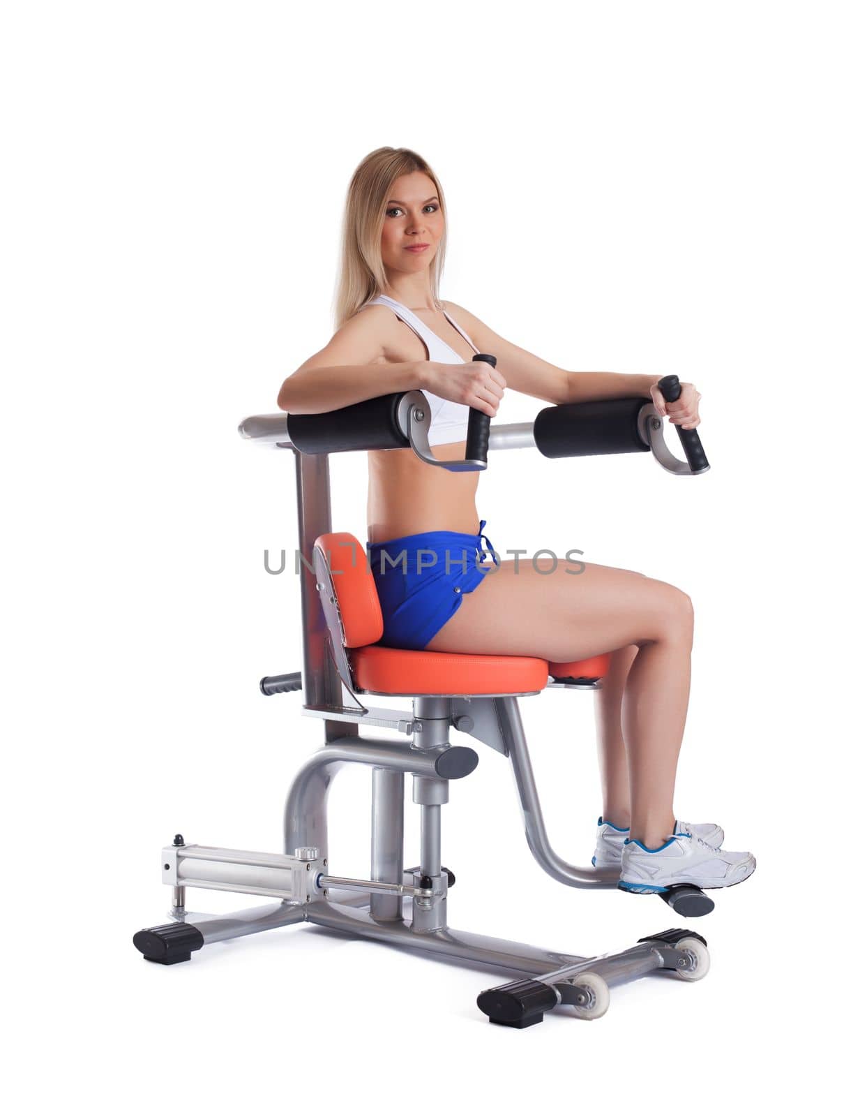 Young athlete on isodynamic trainer isolated on white