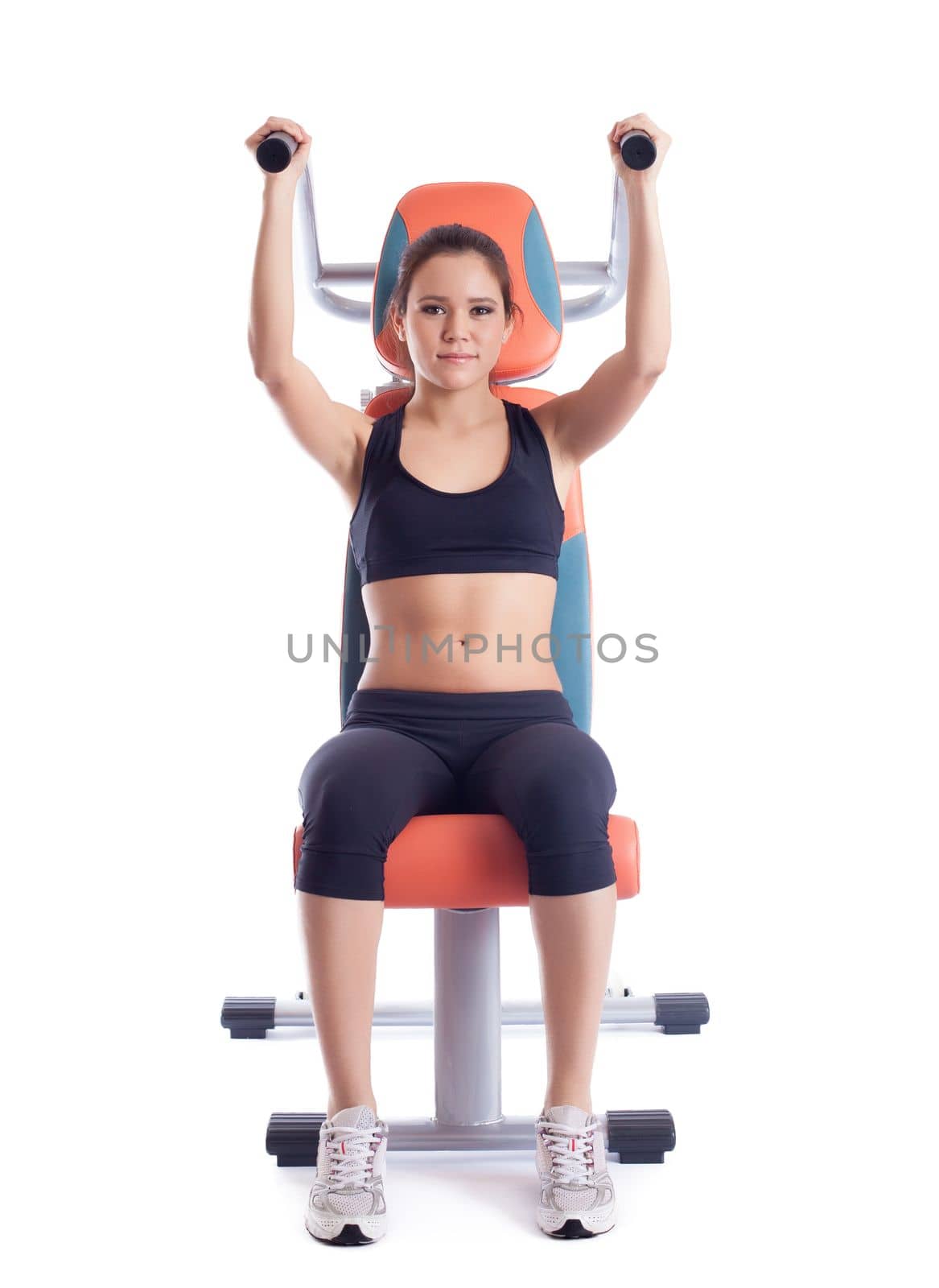 Brunette woman sitting on orange hydraulic exerciser. Isolated on white