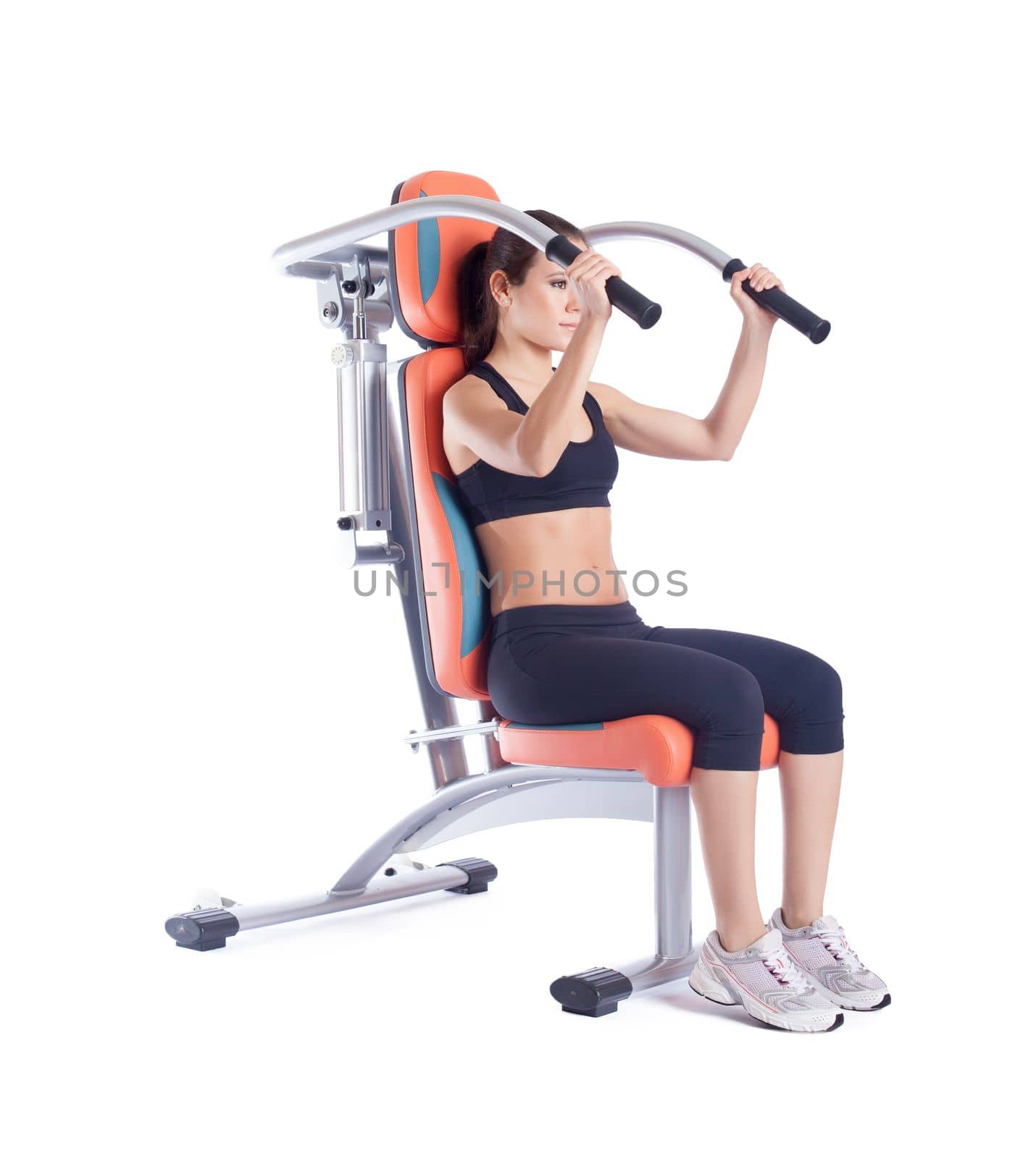Brunette woman sitting on exerciser. Isolated on white