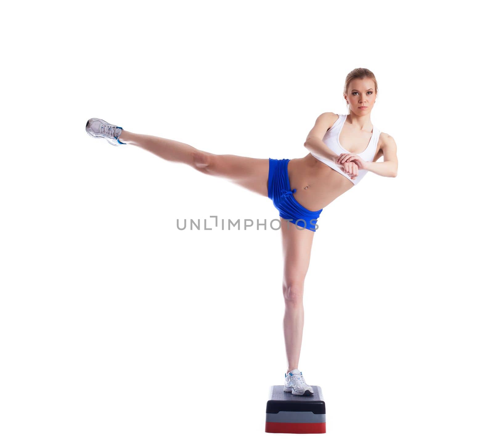 Slim young woman on stepper. Isolated on white