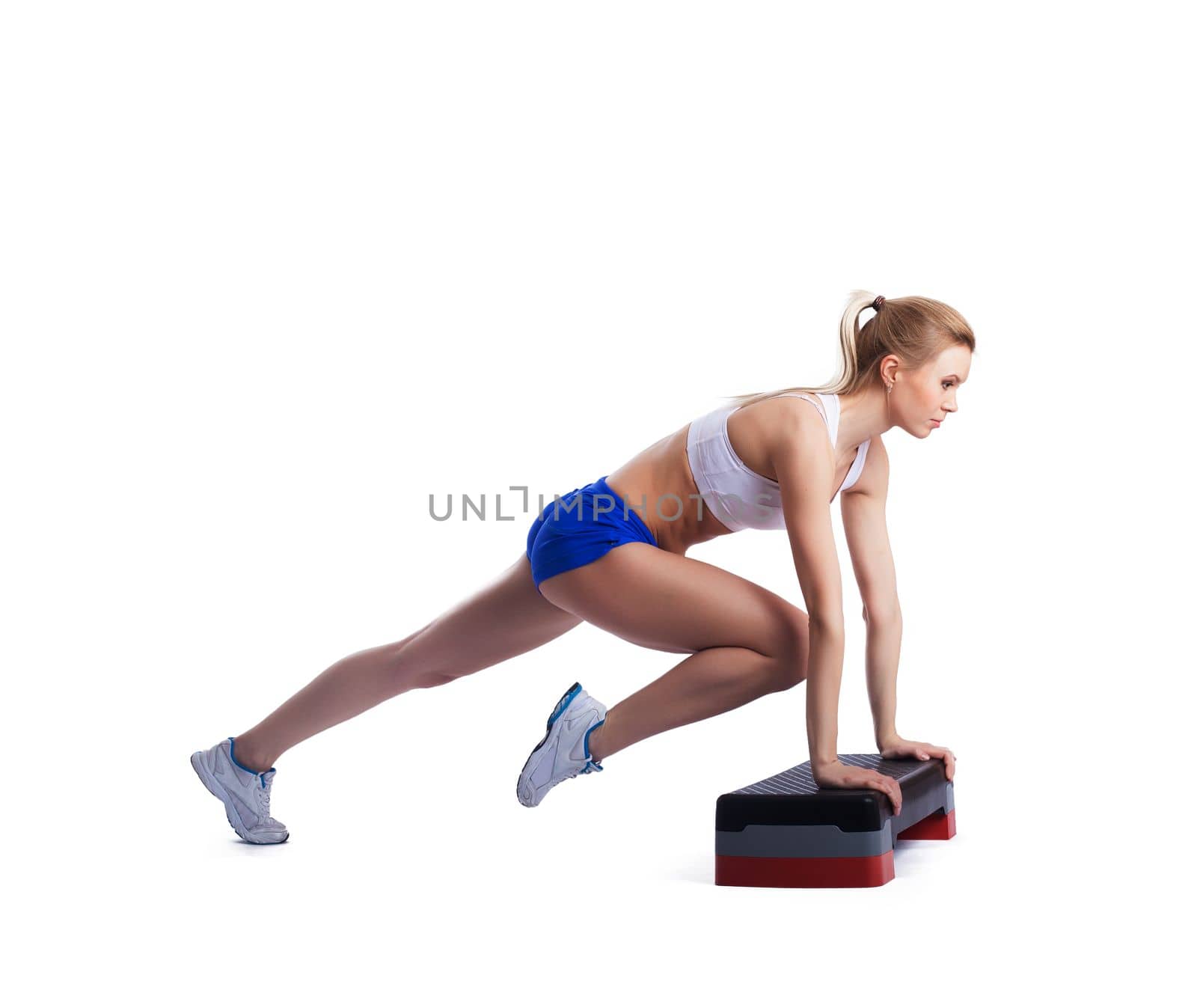 Slim young woman with stepper. Isolated on white