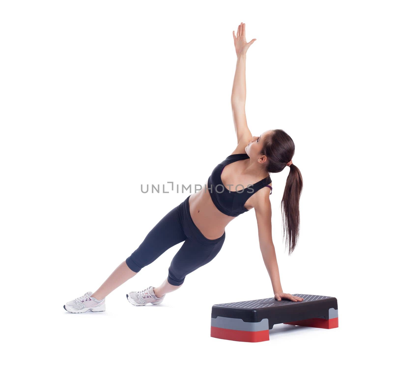 Slim brunette woman with stepper. Isolated on white