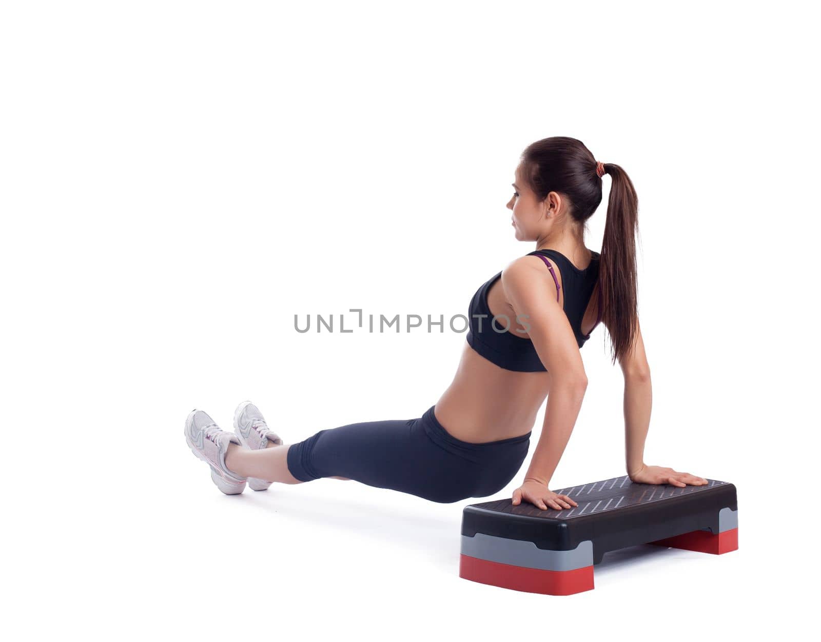 Young brunette woman with stepper. Isolated on white