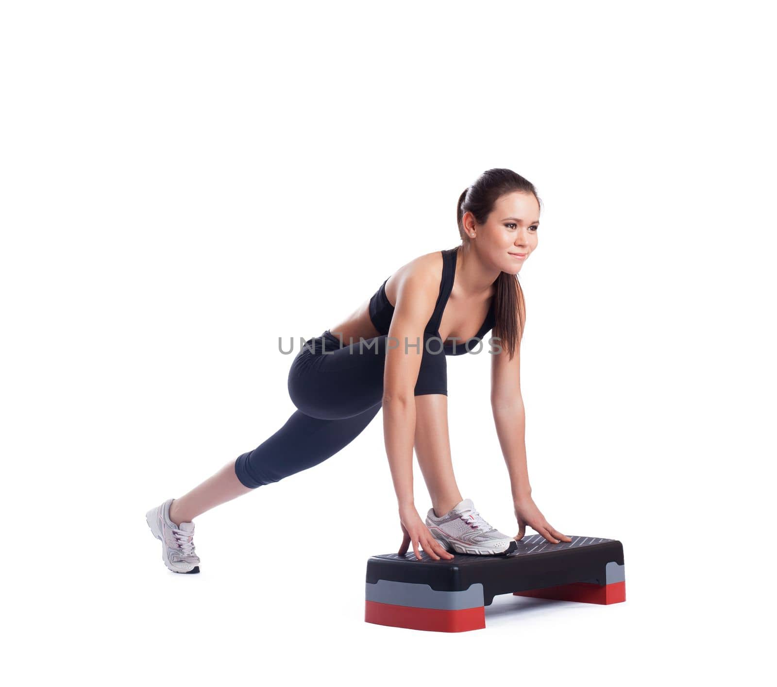 Pretty brunette woman with stepper. Isolated on white
