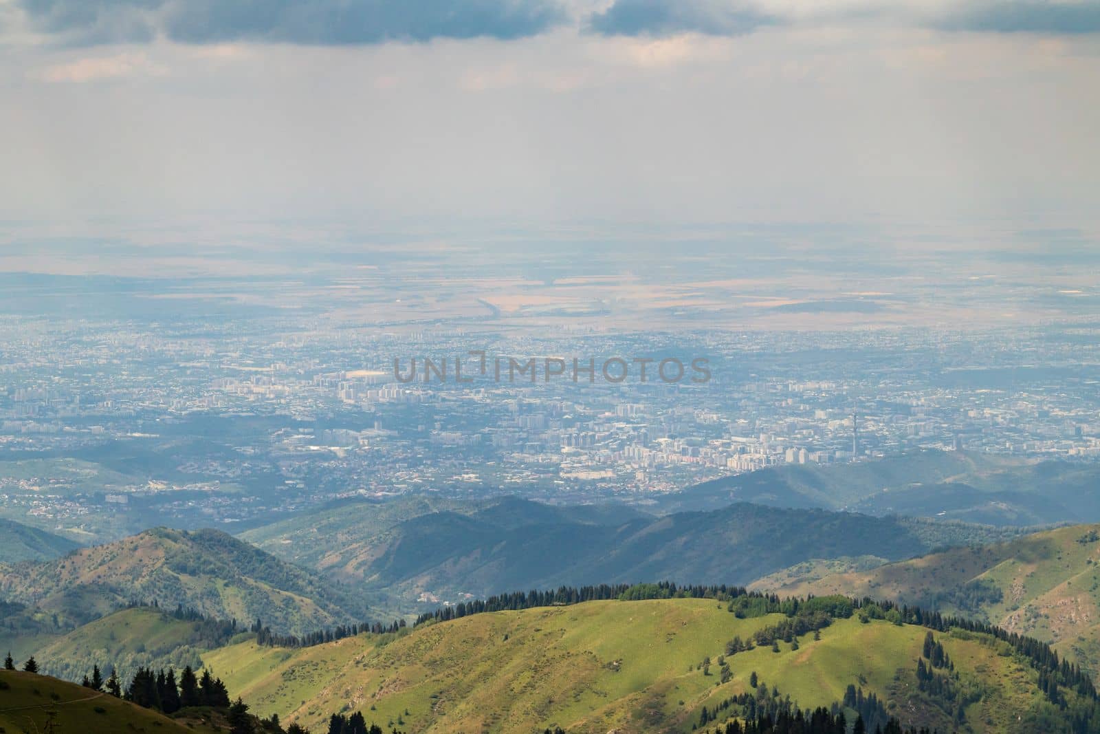View of the city of Almaty in the distance from the side of the Almaty mountains.