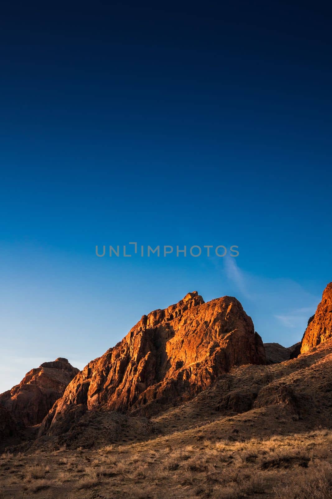 Sunrise rocky picturesque landscape near the Ili River in the Almaty region of Kazakhstan. Copy space, vertical.