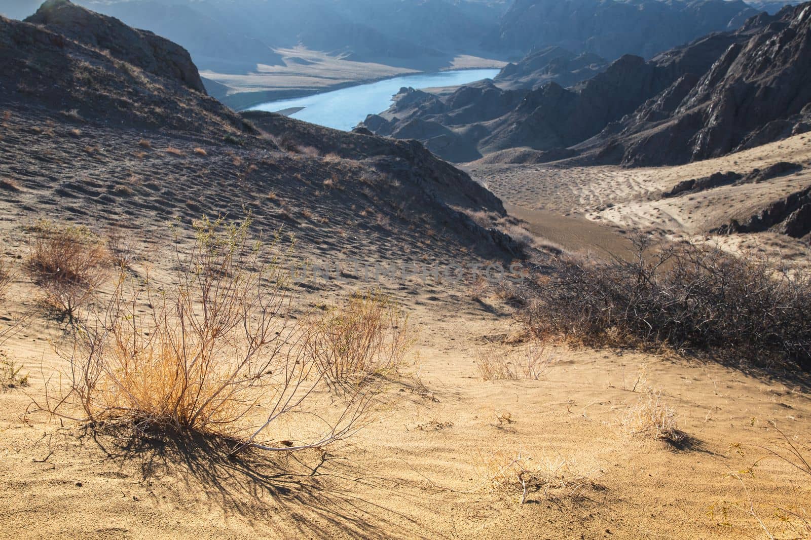View from afar of the river in the arid steppe of Kazakhstan Ili, landscape of central asia.
