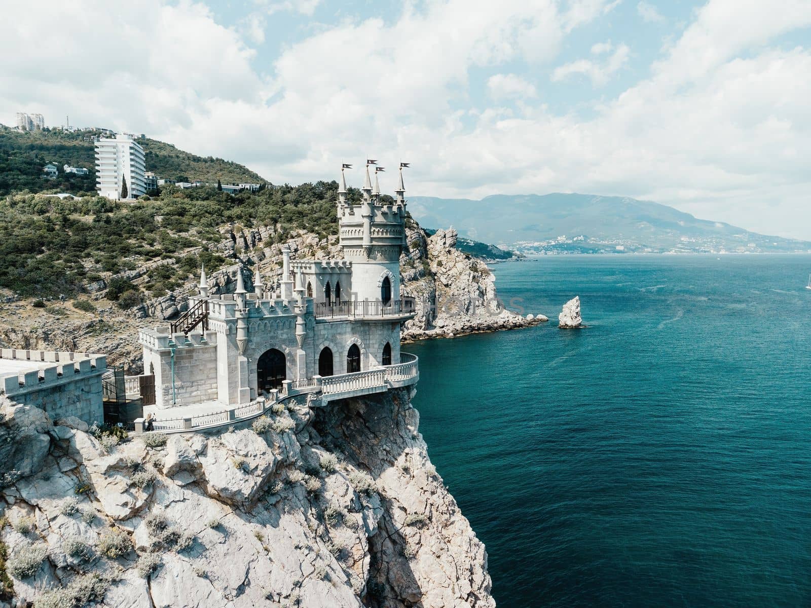 Aerial view of Swallow's Nest castle on the rock in Black Sea. It is a symbol and landmark of Crimea. Beautiful scenic panorama of the Crimea coast. Amazing Swallow's Nest at the precipice.