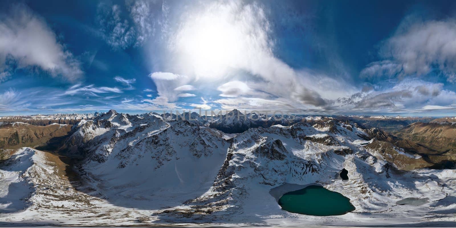 panorama of mountain snow-covered range with turquoise lake, sunny day with clouds by yanik88