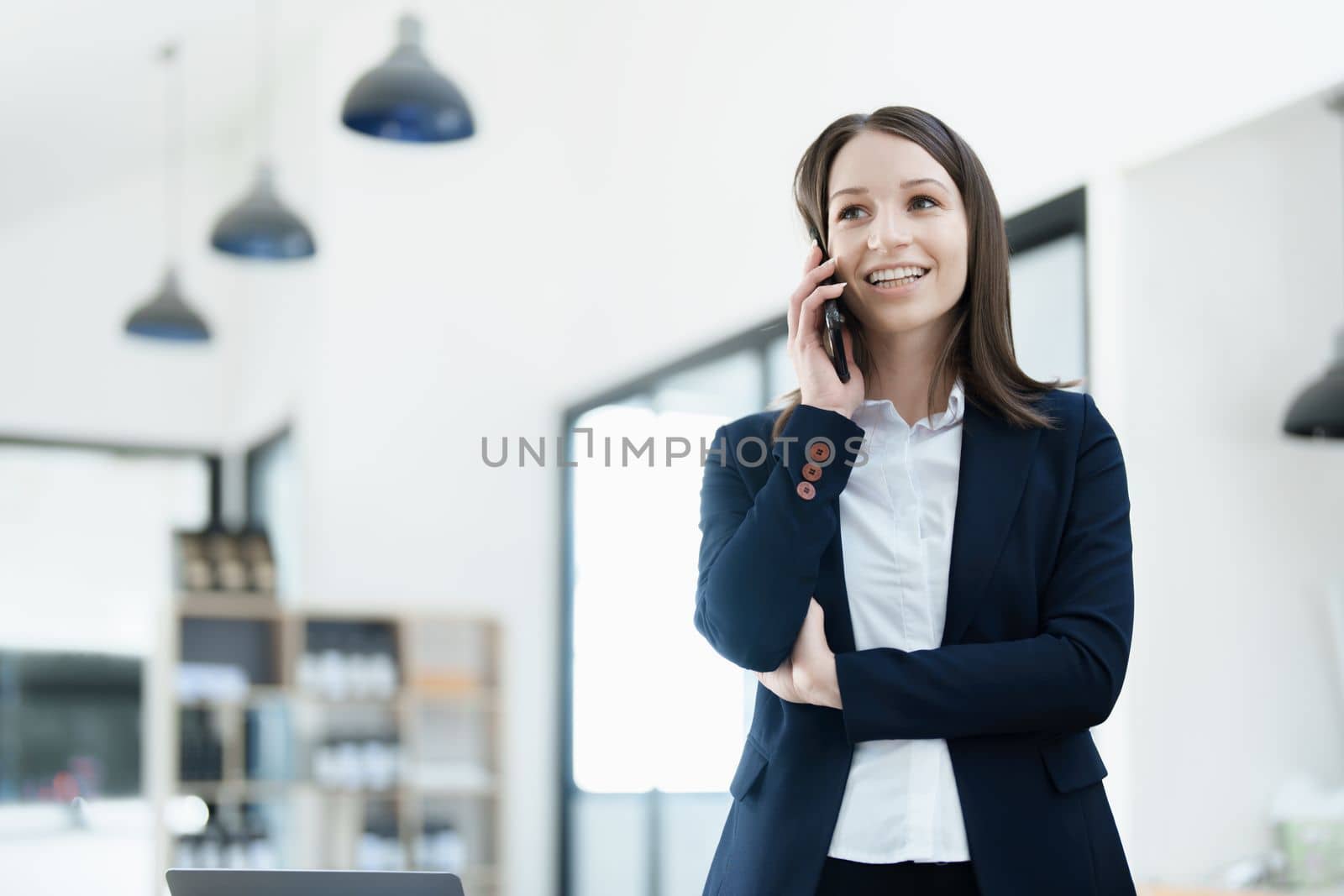 business owner or Asian female marketers are using business phones in office work.