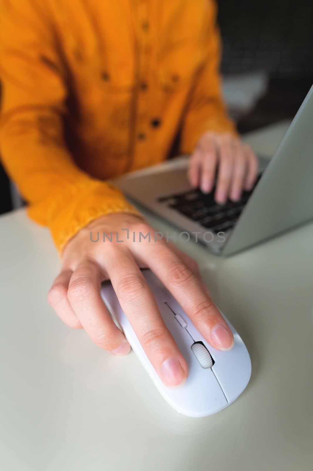 Close-up woman searching and clicking mouse using laptop, online shopping concept. Blurred background by yanik88