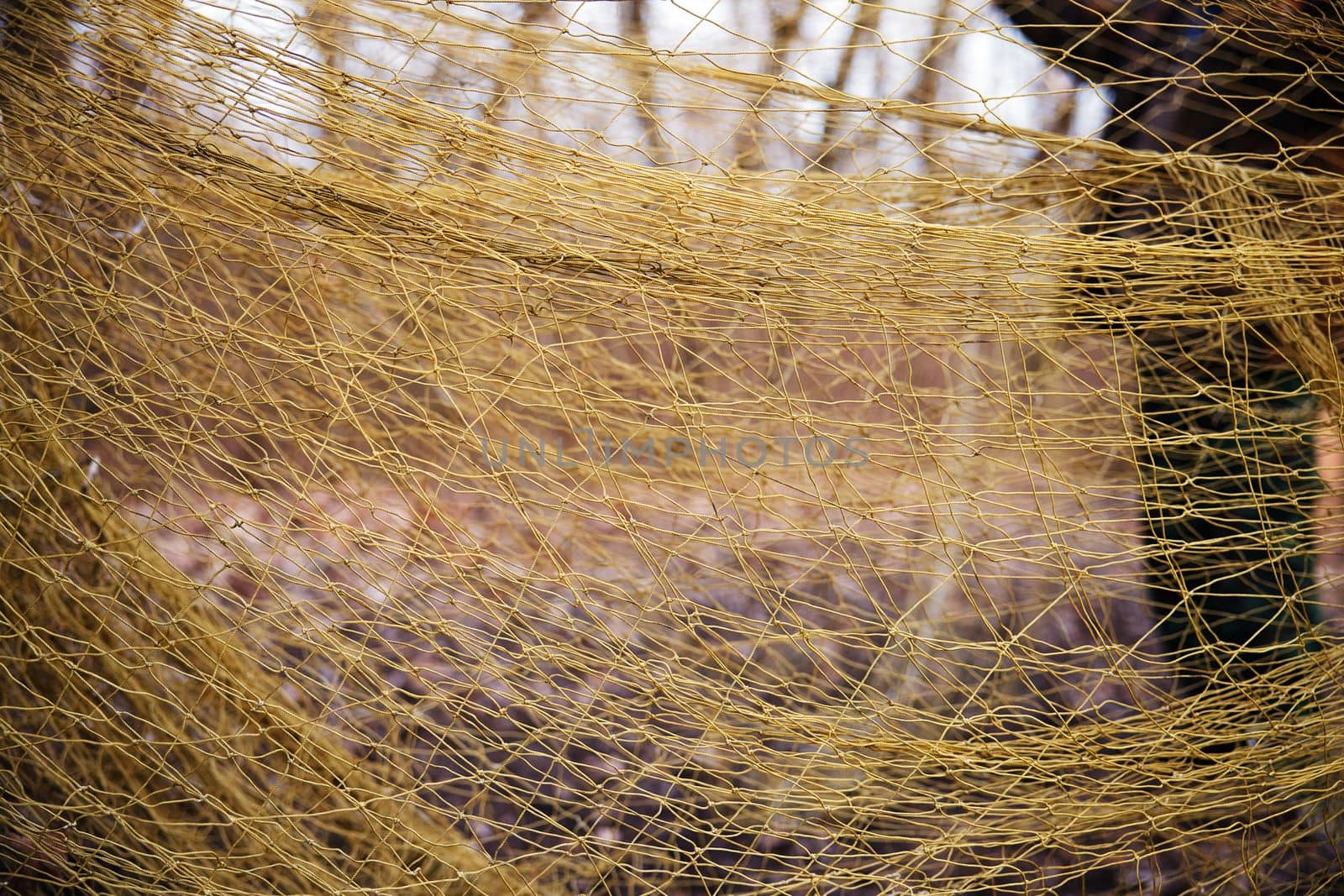 Large mesh net for catching animals. Rescue and relocation of animals. Background from the net. Nets for catching wild animals in the forest. Trapping game animals. Unraveling trapping nets.