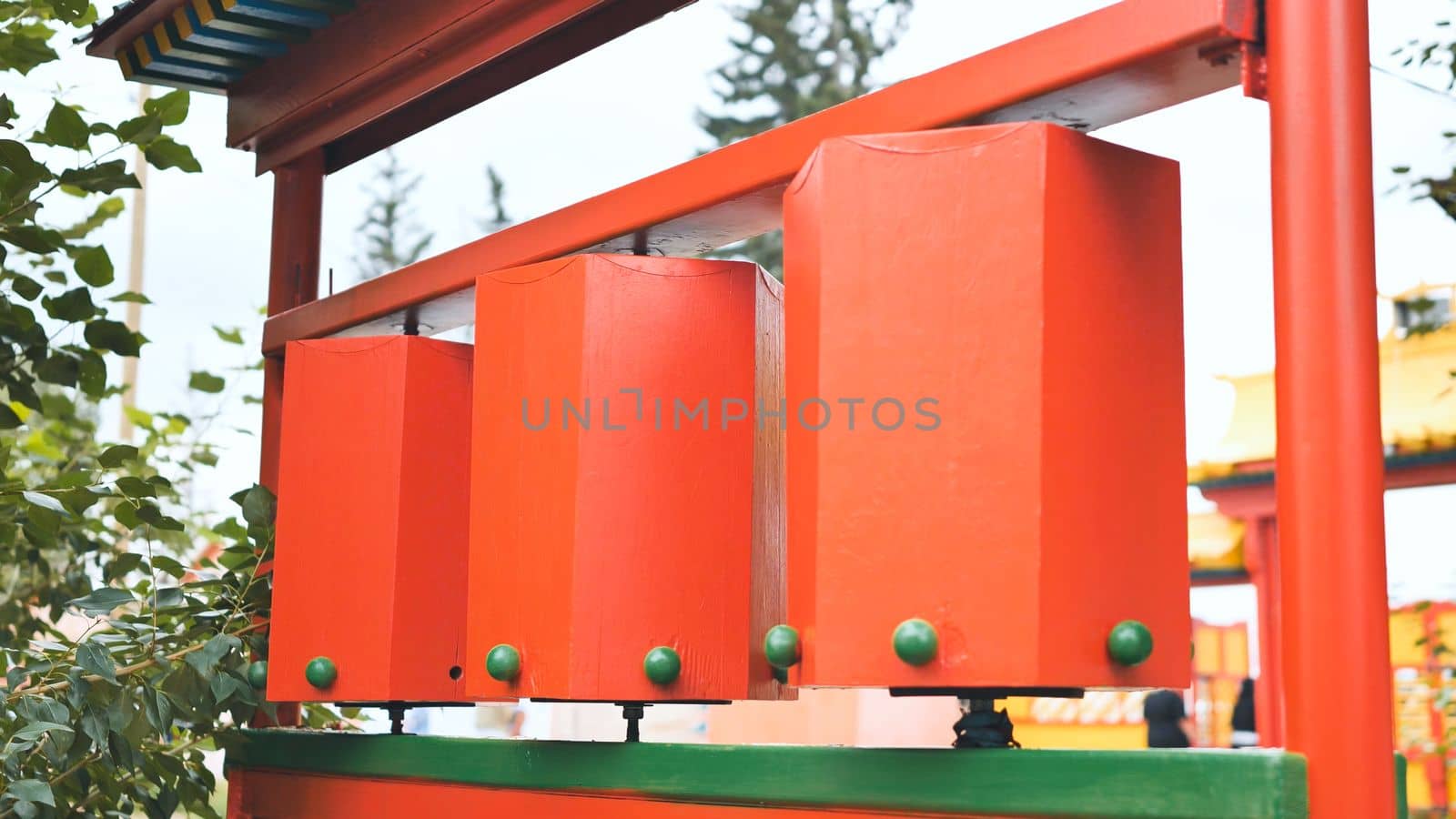Rotation of the red prayer drums outside the Buddhist temple