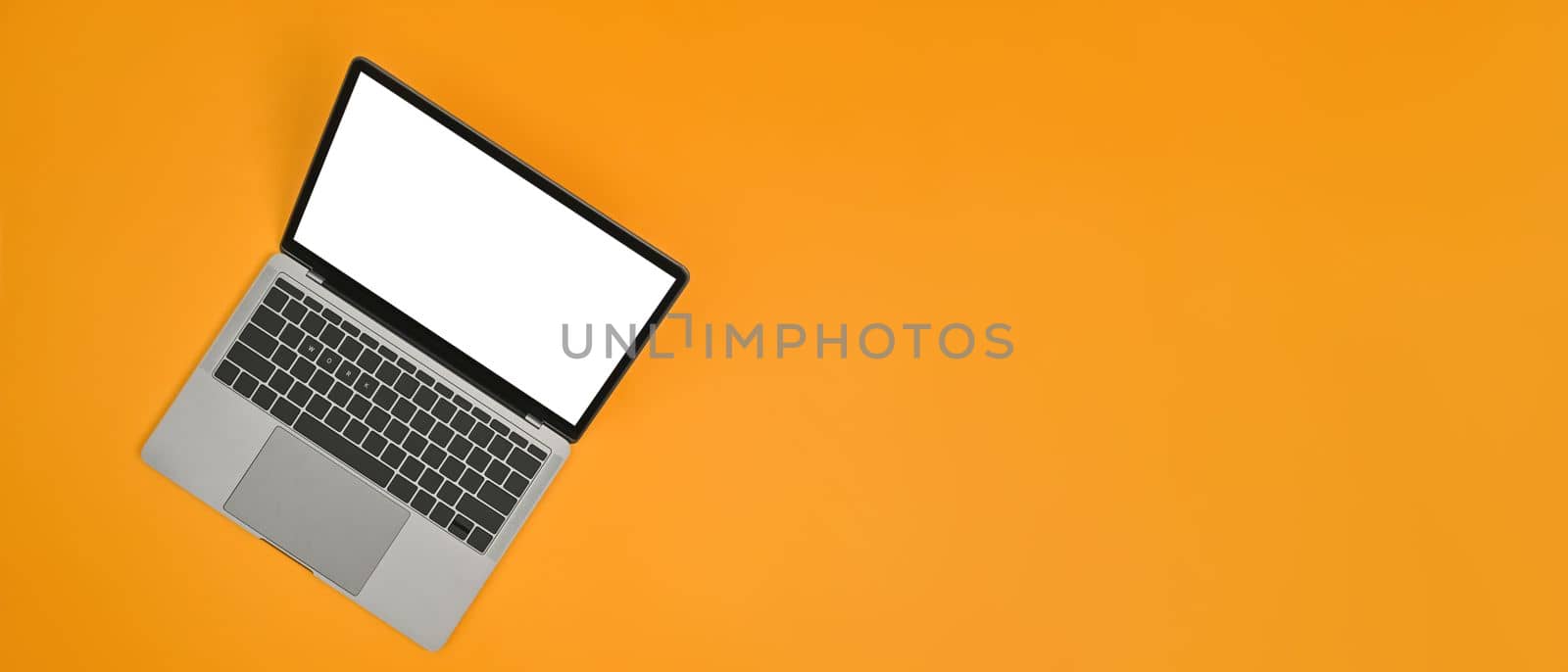 Mock up laptop computer with empty screen on yellow background. Copy space for text information or content by prathanchorruangsak
