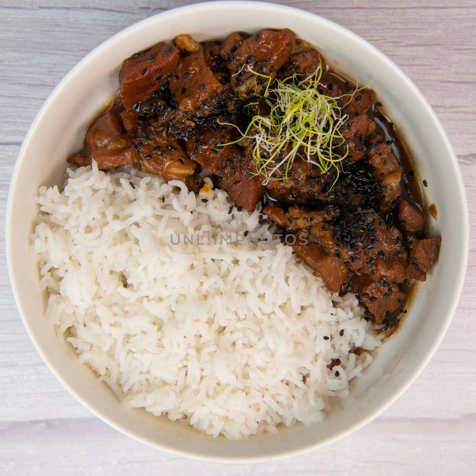 Caramel pork recipe with rice and black sesame seeds. High quality photo