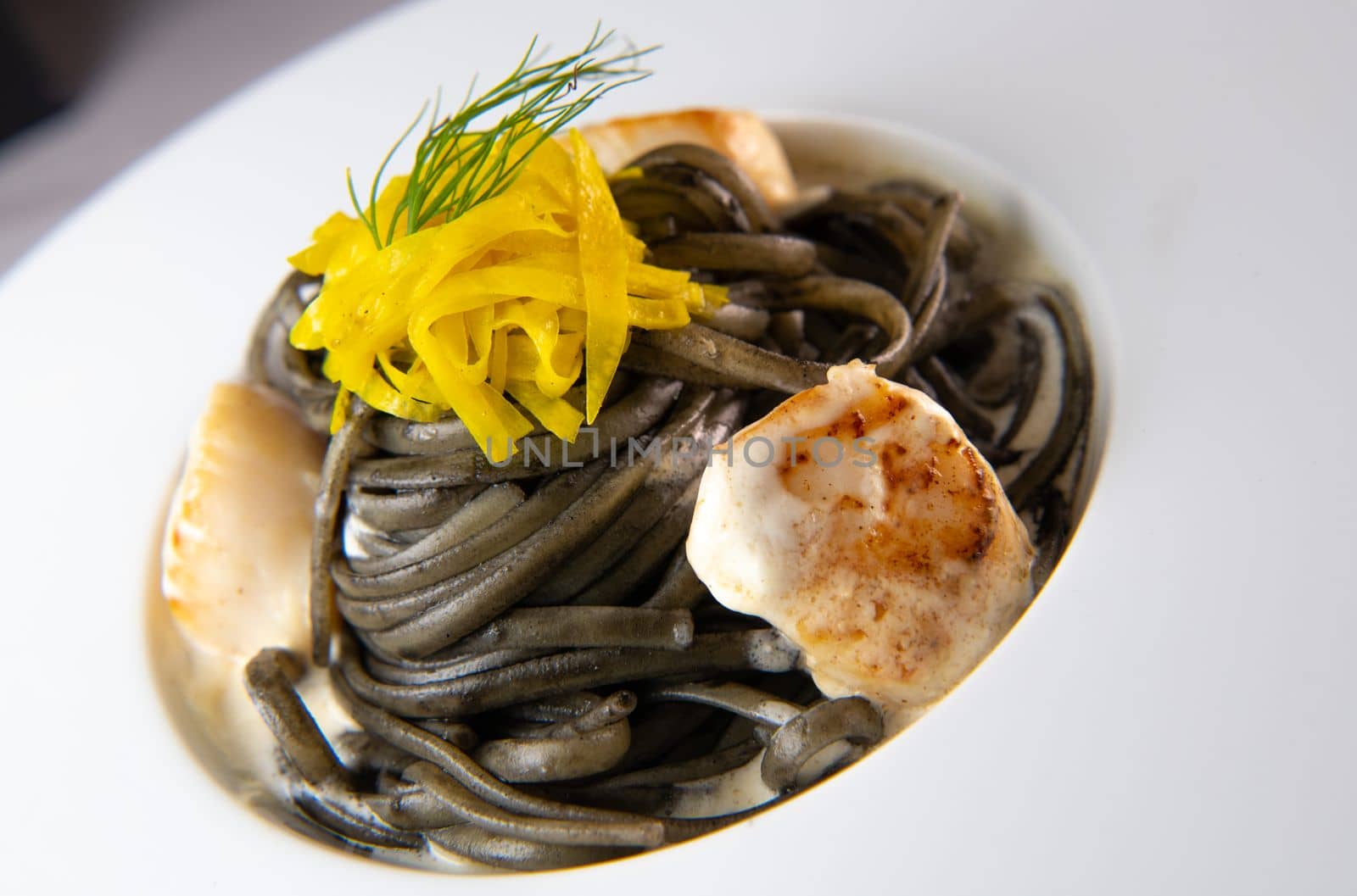 Recipe for Linguine Pasta with squid ink and scallops, yellow chioggia beet. High quality photo