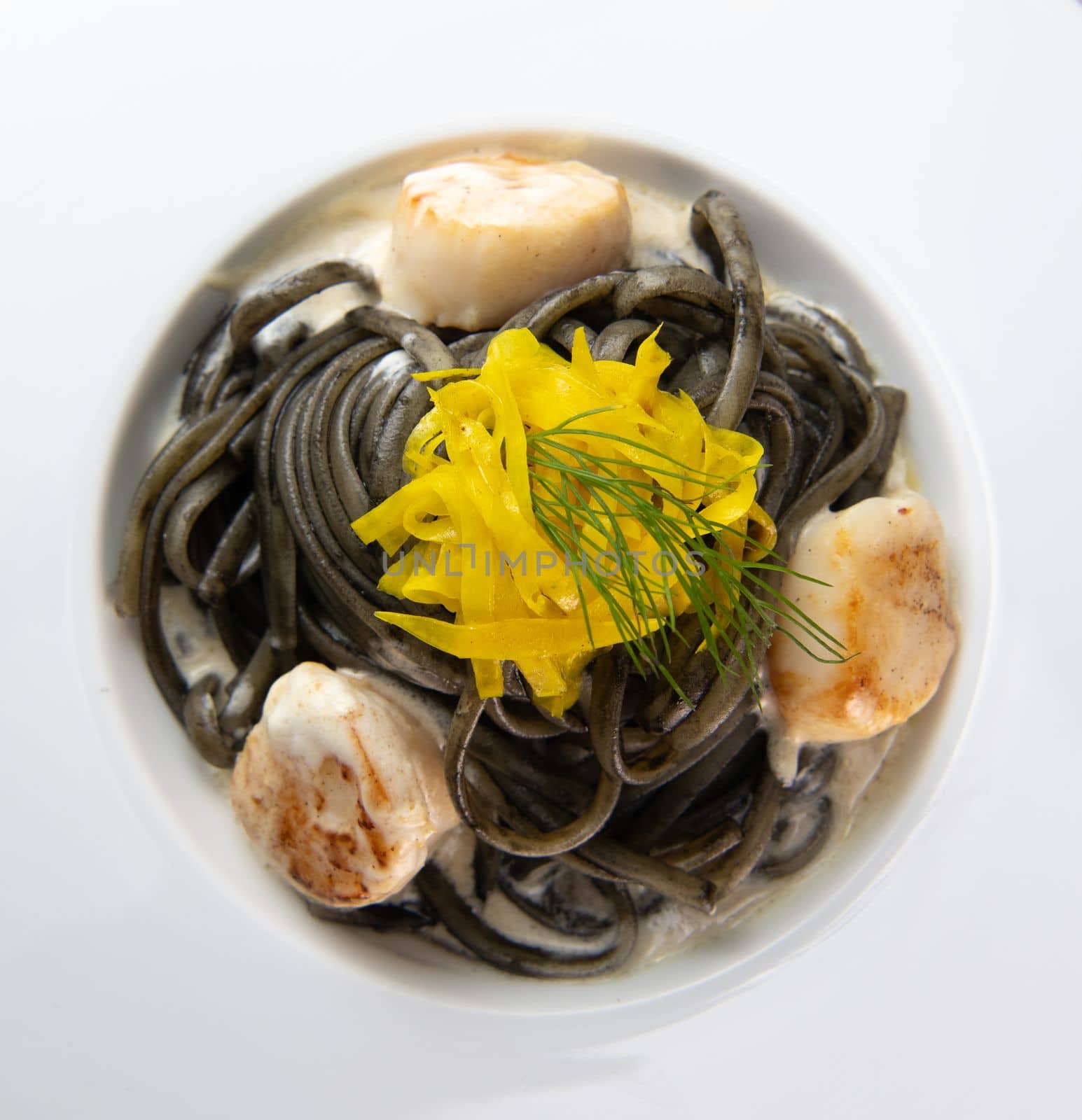 Recipe for Linguine Pasta with squid ink and scallops, yellow chioggia beet. High quality photo