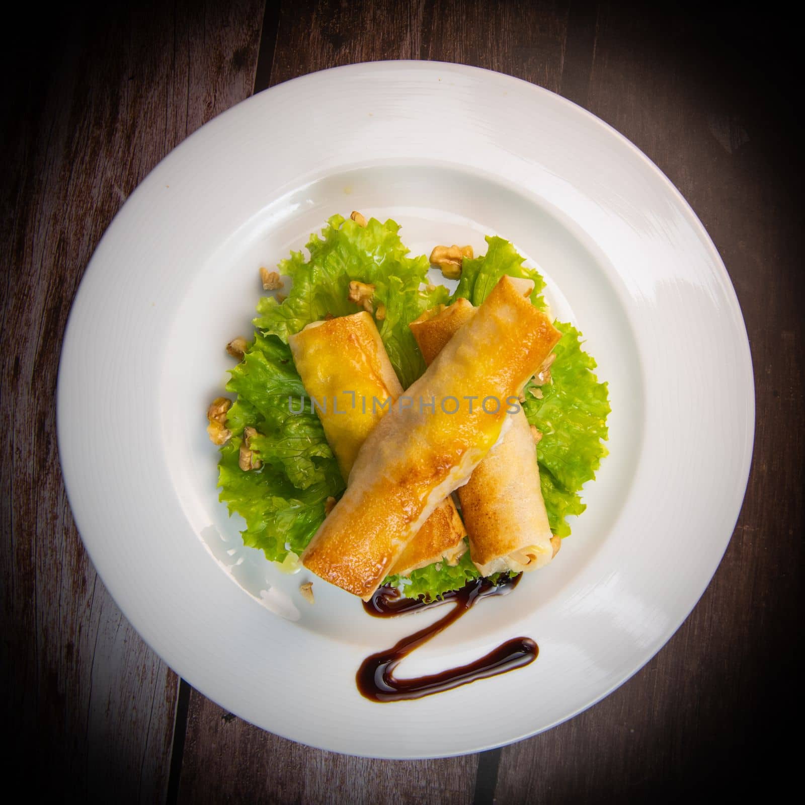 Brick recipe with goat cheese and honey in the oven with a walnut salad. High quality photo