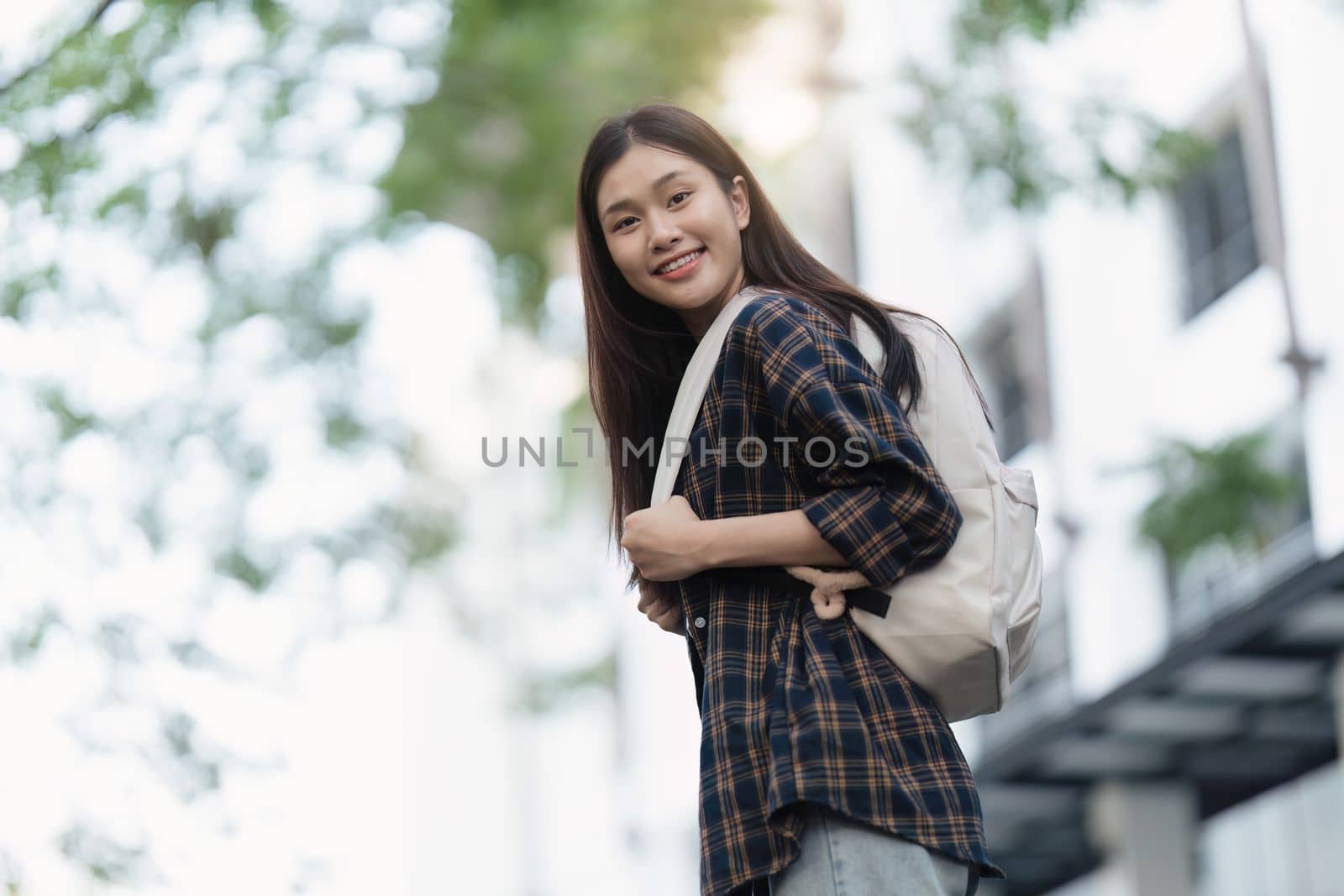 Portrait of beautiful student woman in university ready for learning. Education, scholarship and happy and proud female learner at university by itchaznong