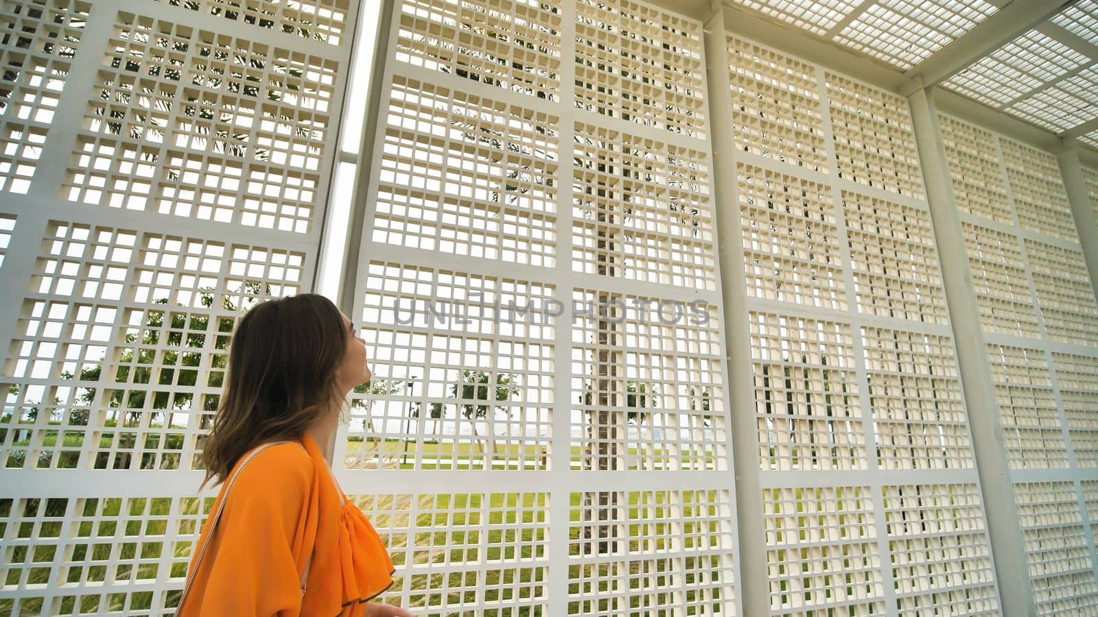A girl comes to the Louvre Museum located next to Abu Dhabi