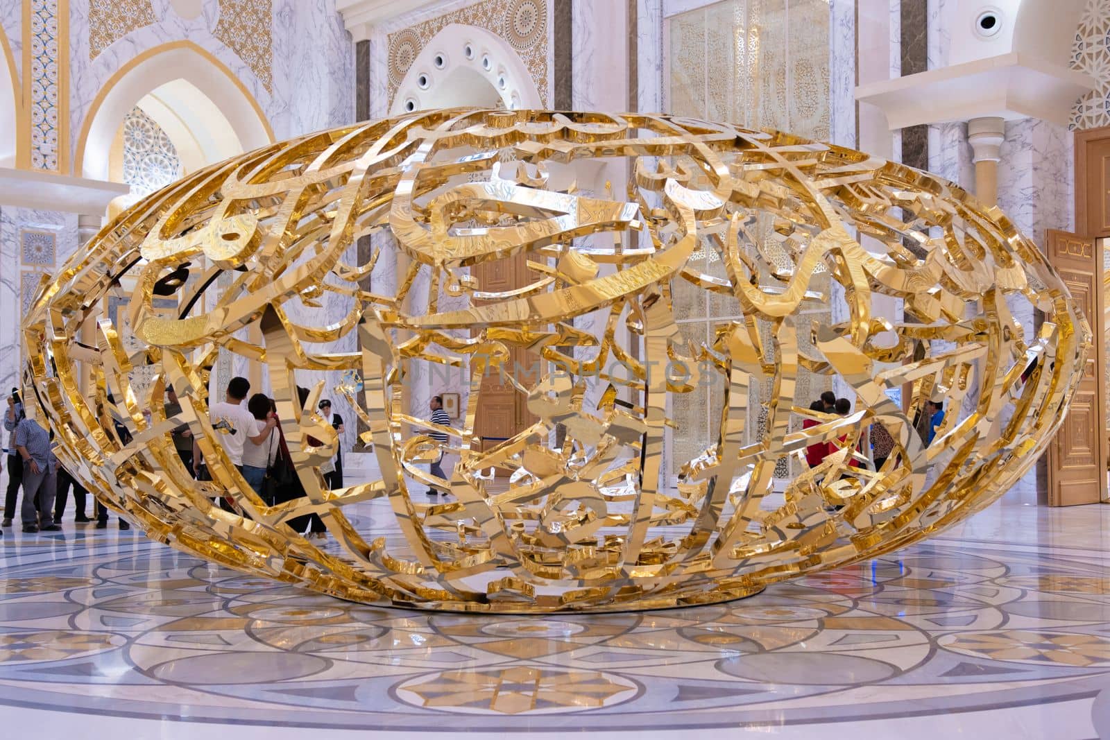 Abu Dhabi, Arab Emirates, March, 19, 2019. People walking near sculptural composition the power of words in Presidential Palace, Palace of Qasr al-Watan the Palace of the nation in Abu Dhabi