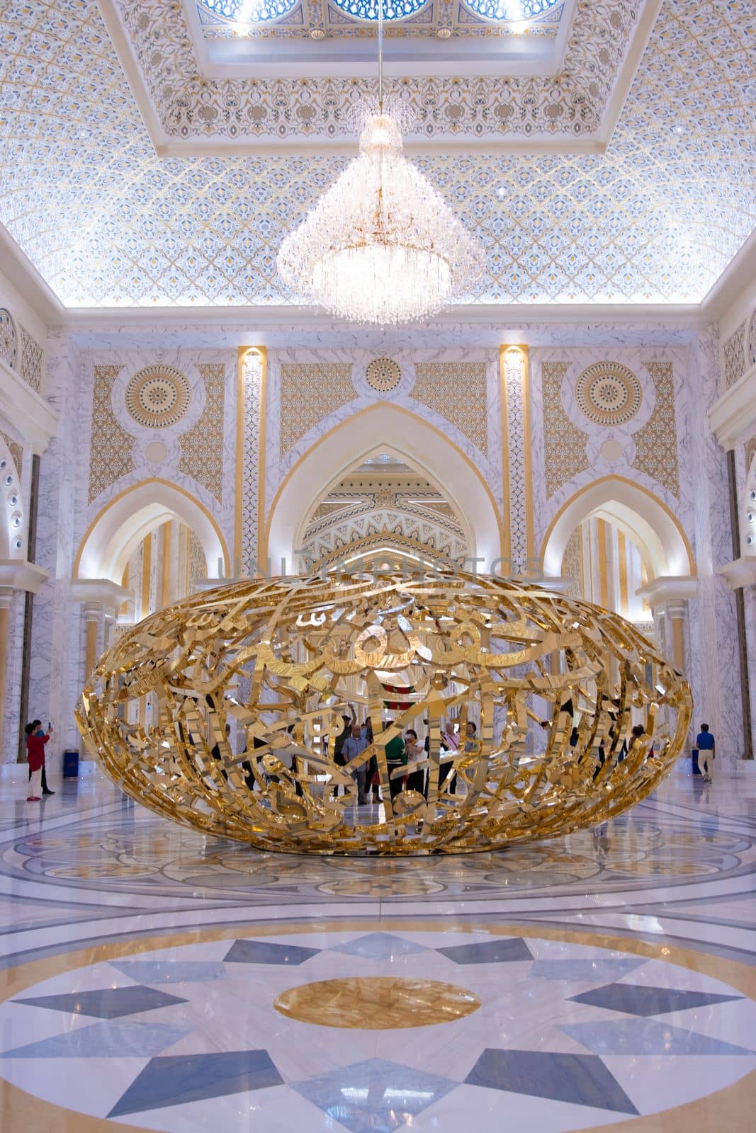 Abu Dhabi, Arab Emirates, March, 19, 2019. People walking near sculptural composition the power of words in Presidential Palace, Palace of Qasr al-Watan the Palace of the nation in Abu Dhabi