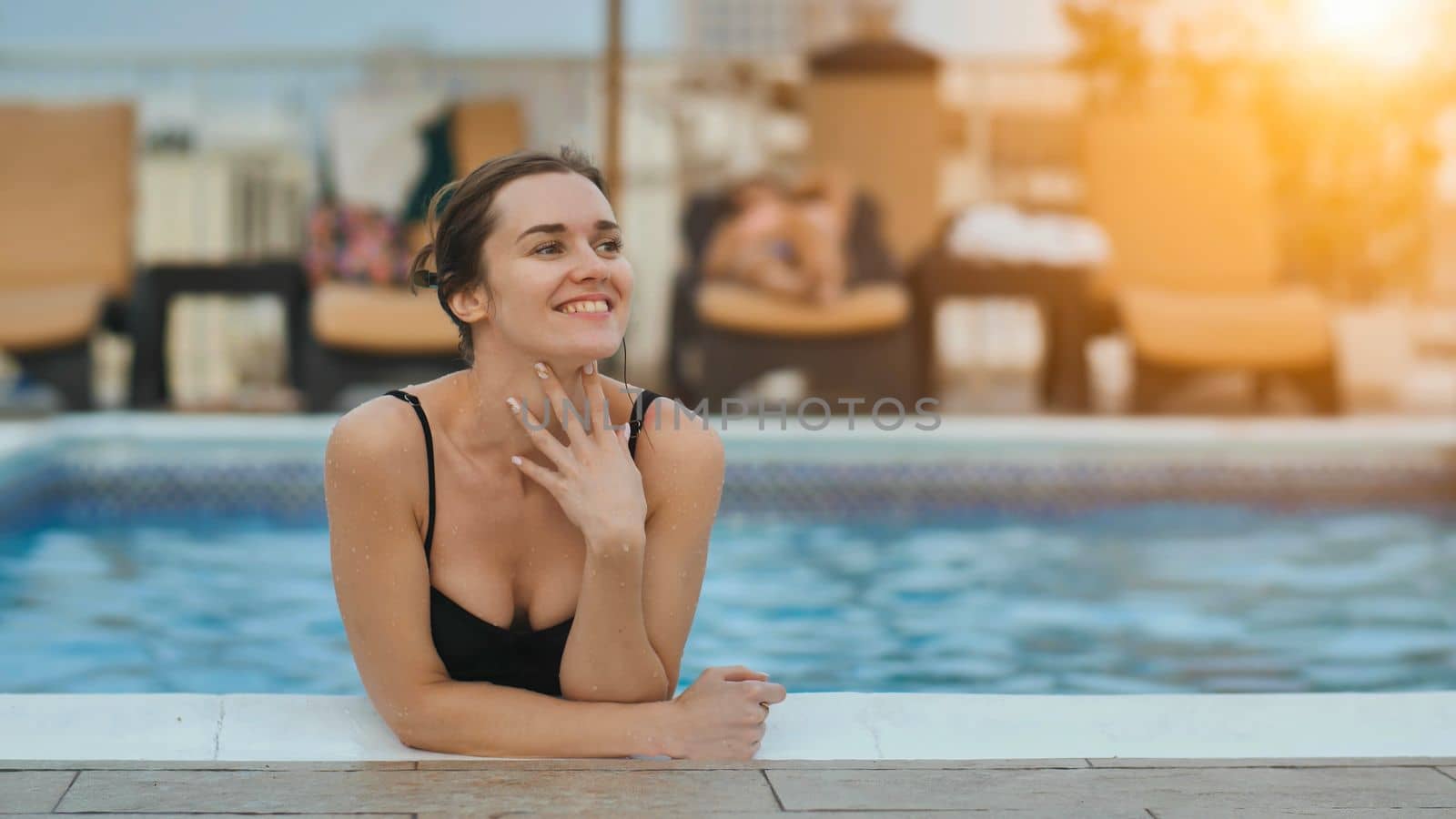 Girl after swimming posing in the pool