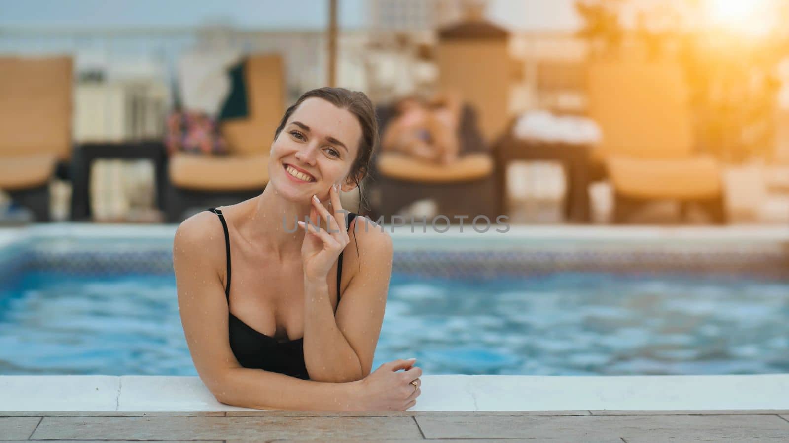 Girl after swimming posing in the pool