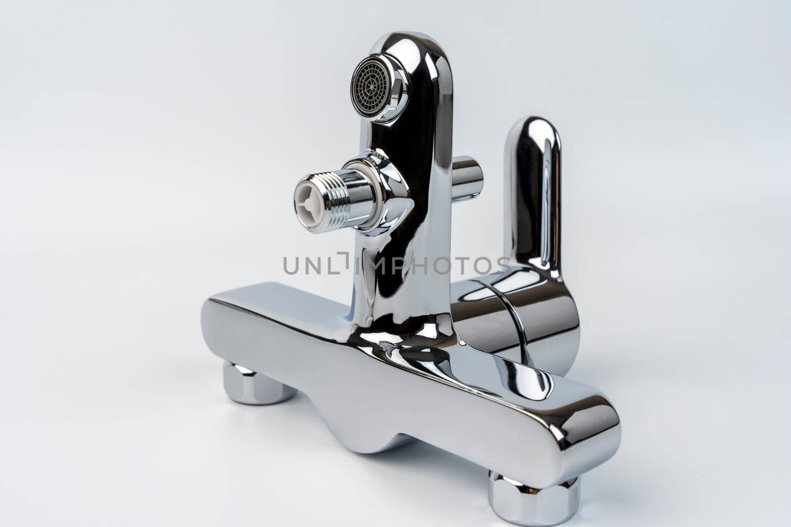 new shiny bath faucet on a white background. Bath mixer before installation. mounting nuts for mounting. Plumbing, renovation. close-up