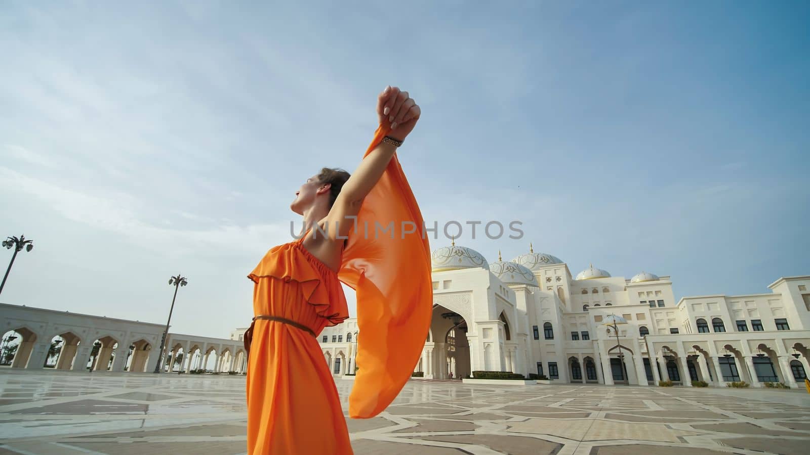 Girl posing on the background of the presidential palace in Abu Dhabi