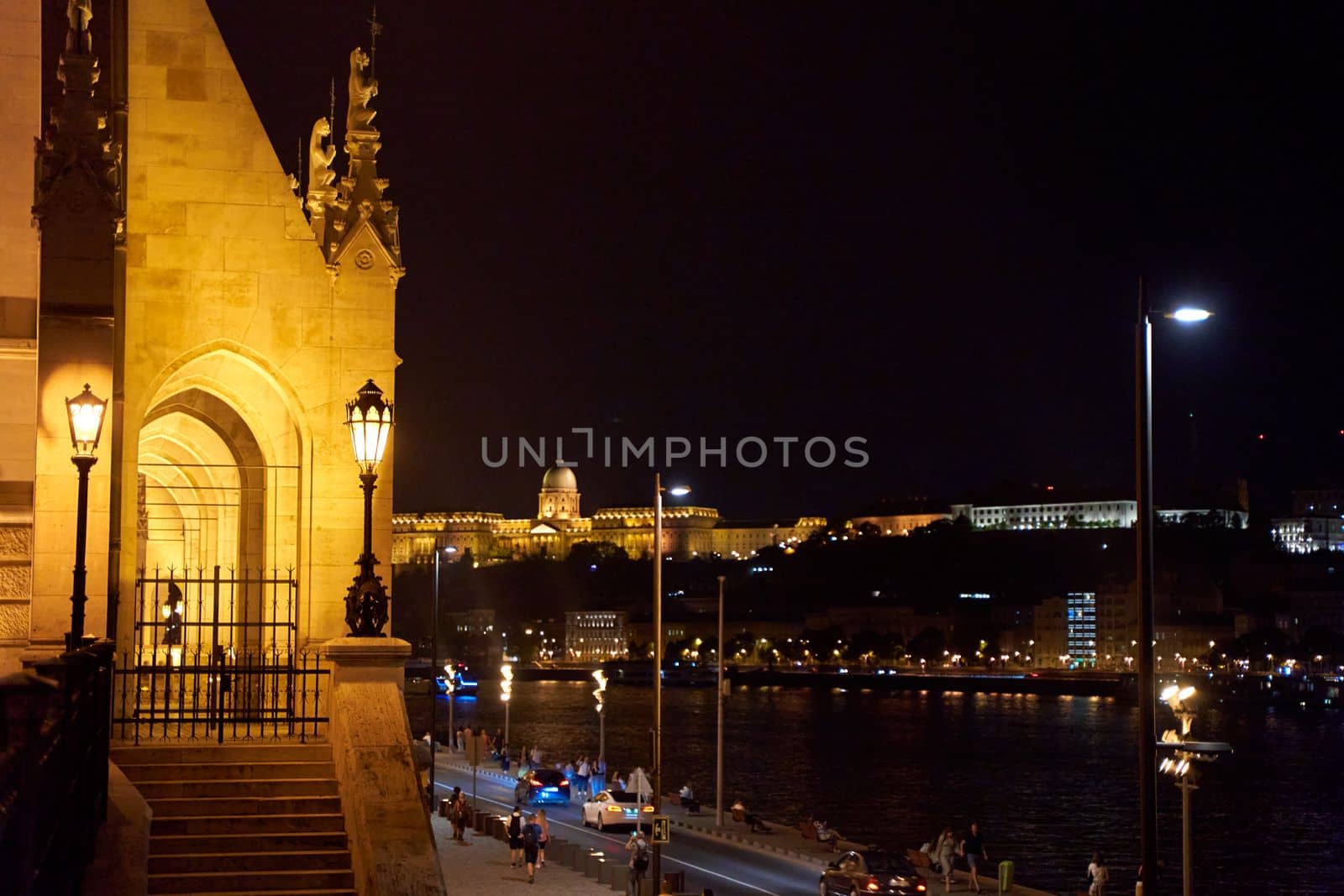 Evening photo of the Parliament building in Budapest.The majestic Saxon architecture is illuminated with warm yellow light. Budapest, Hungary - 08.24.2022