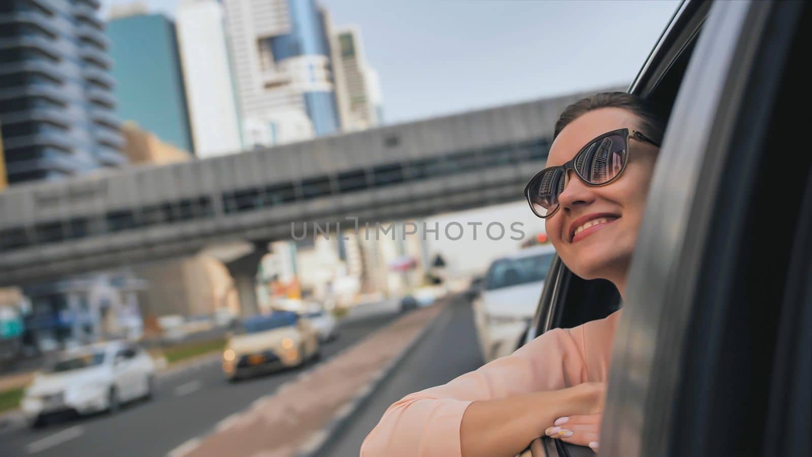 Happy Girl driving a car in Dubai. UAE