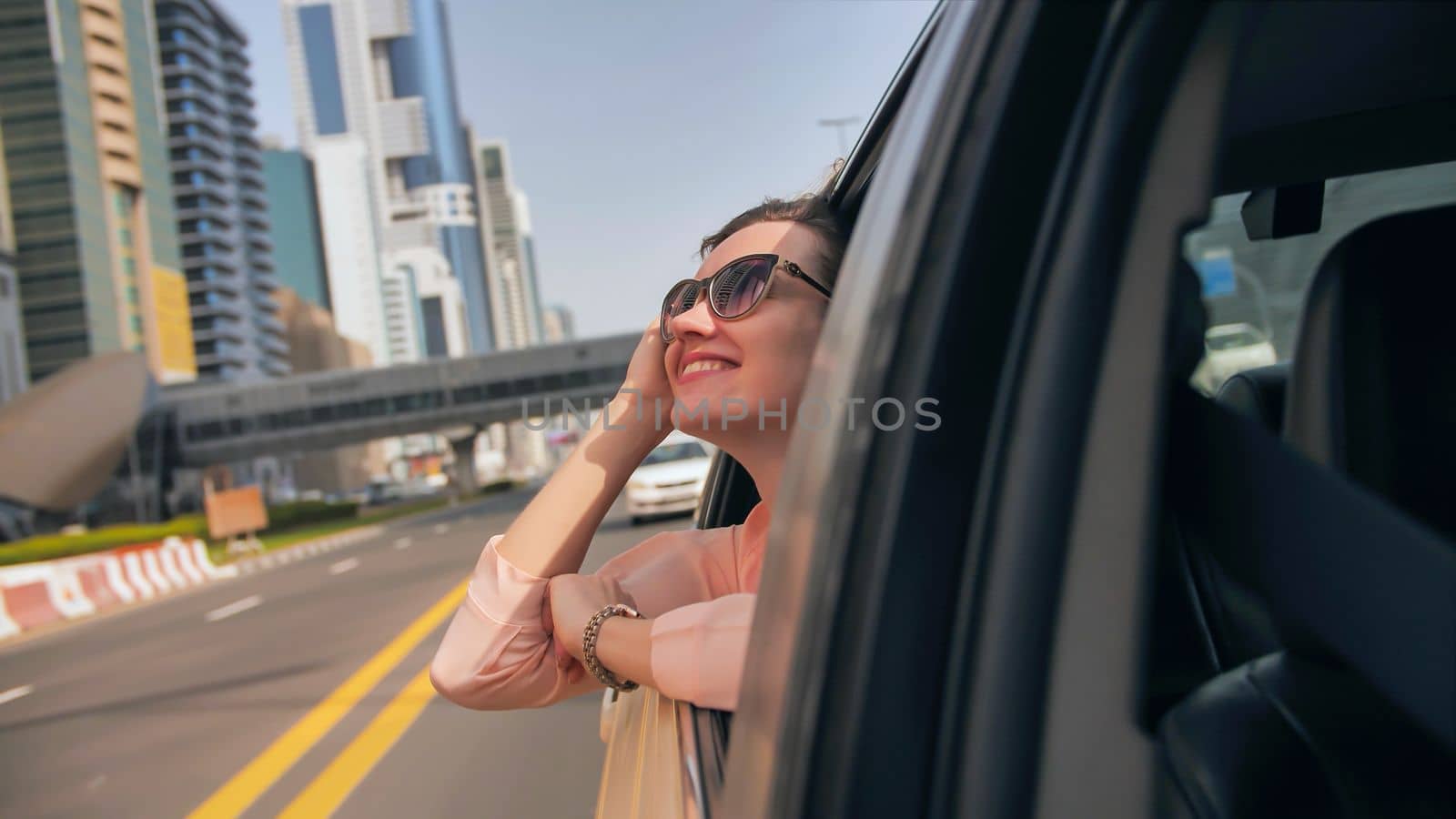 Happy Girl driving a car in Dubai