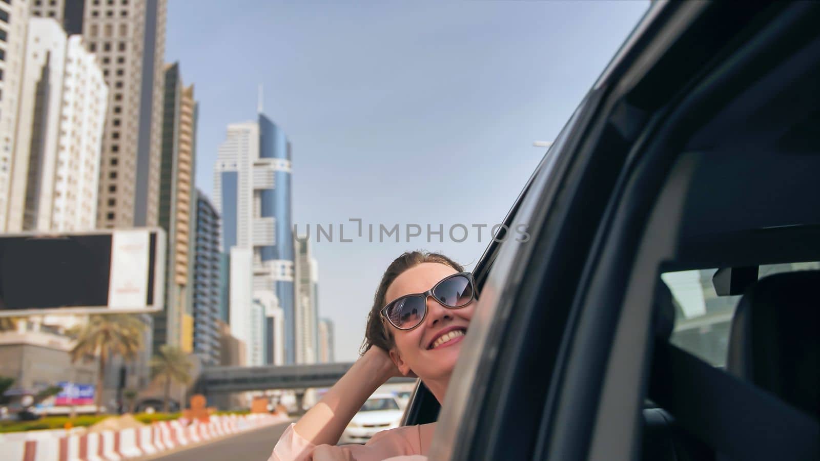 Happy Girl driving a car in Dubai