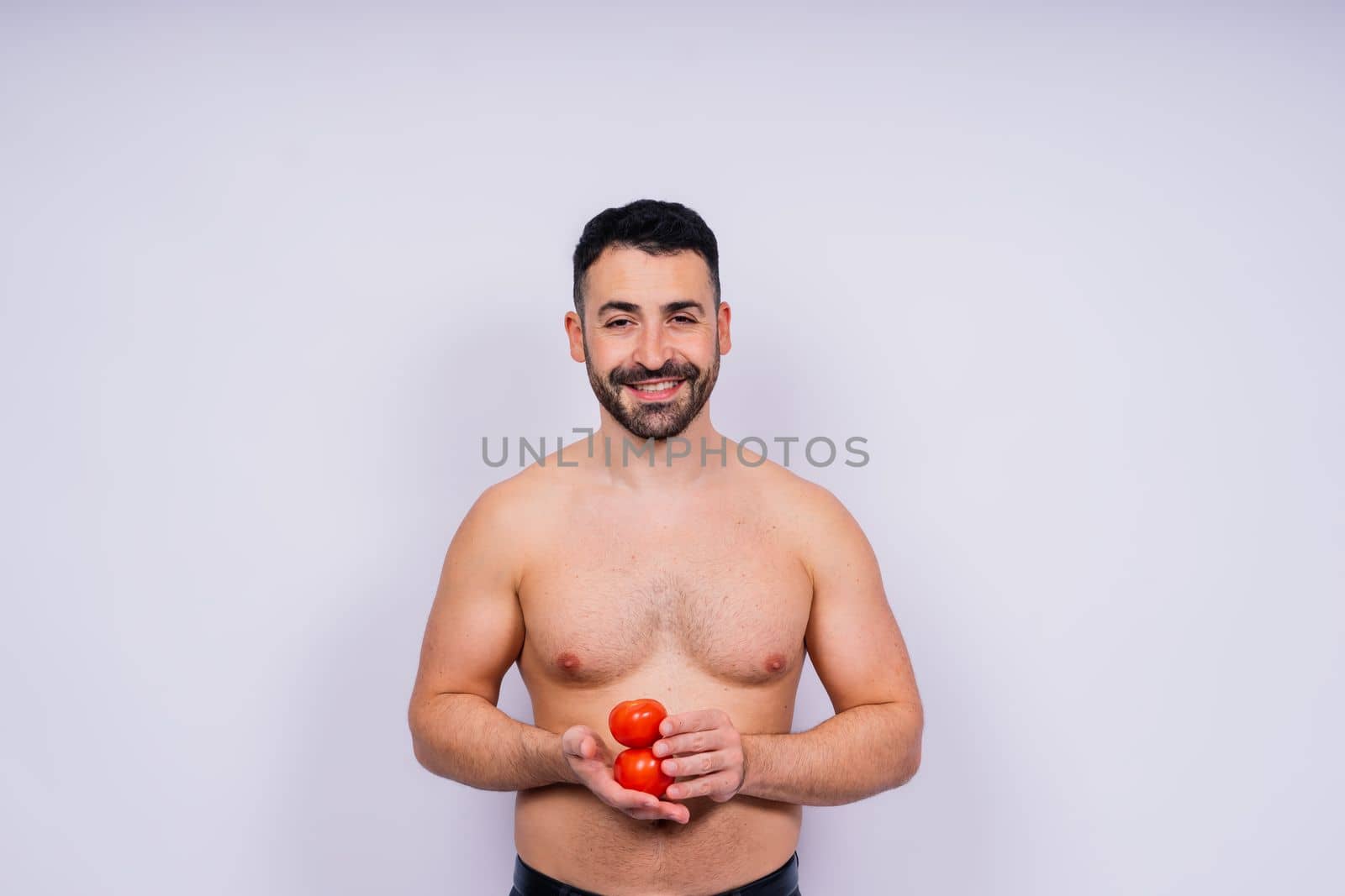 Full isolated studio picture from a young naked man with underwear and tomato by Zelenin