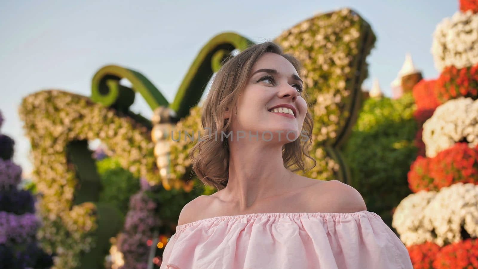 A girl walks through a beautiful fairytale park in Dubai