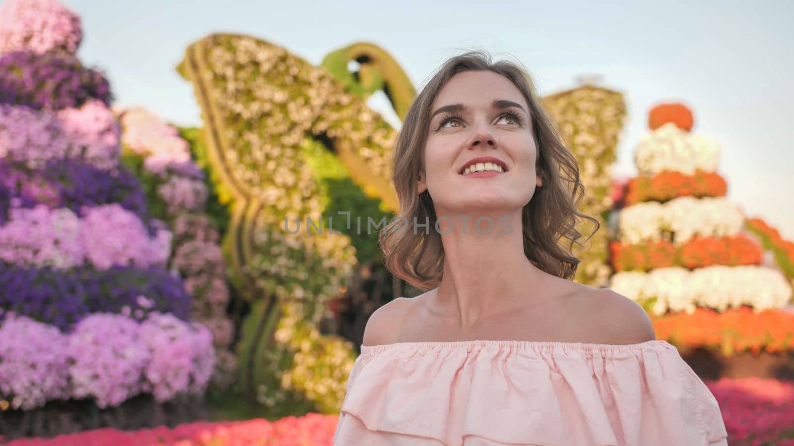 A girl walks through a beautiful fairytale park in Dubai