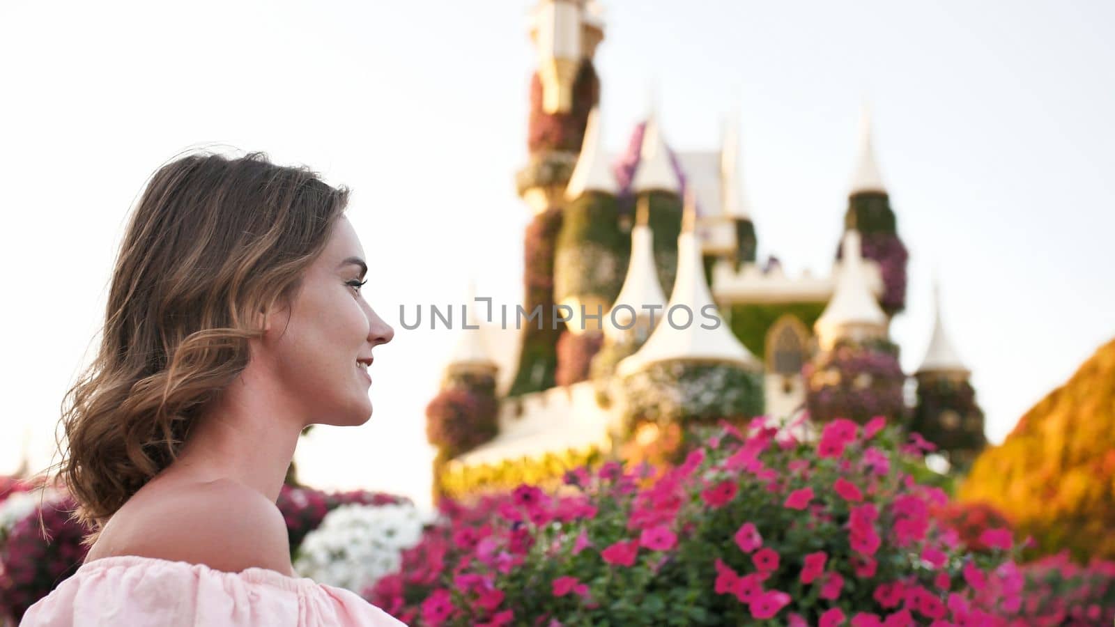 A girl walks through a beautiful fairytale park in Dubai