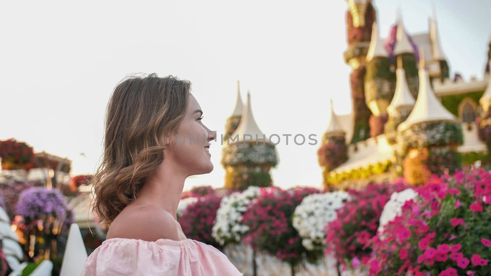 A girl walks through a beautiful fairytale park in Dubai