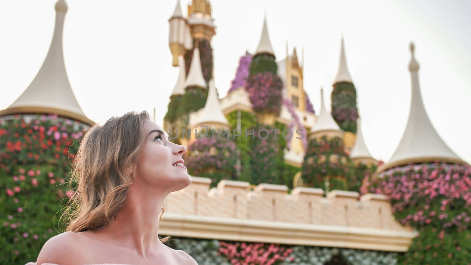 A girl walks through a beautiful fairytale park in Dubai