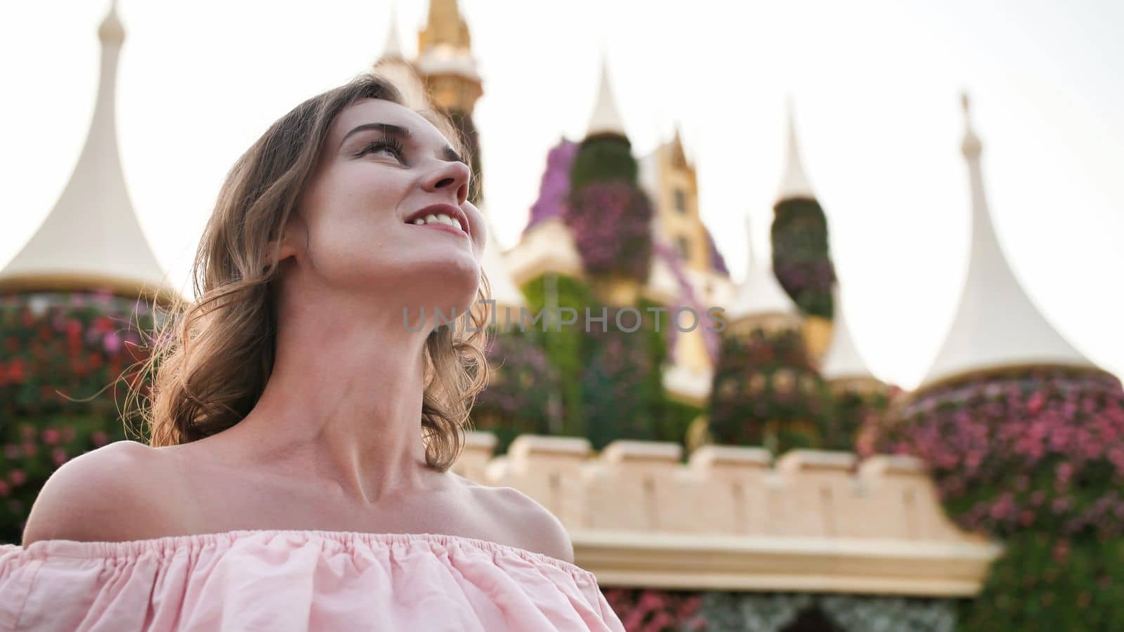 A girl walks through a beautiful fairytale park in Dubai