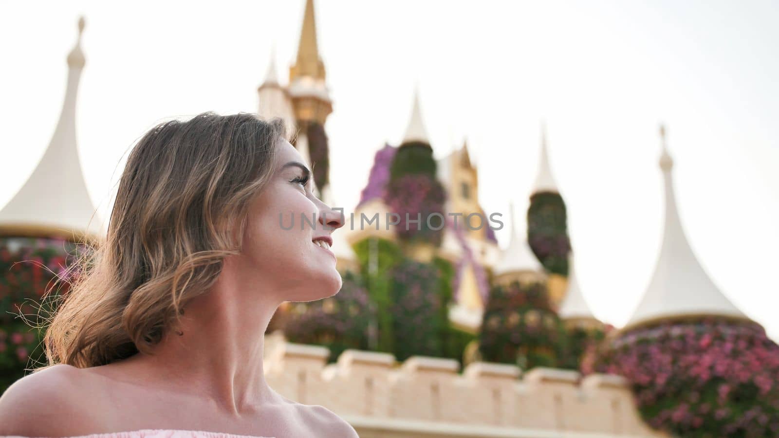 A girl walks through a beautiful fairytale park in Dubai