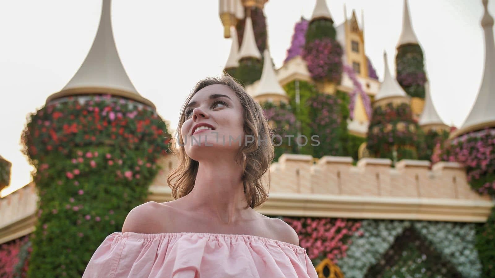 A girl walks through a beautiful fairytale park in Dubai