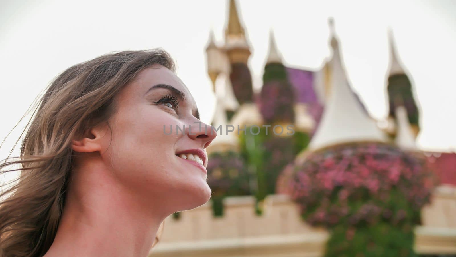 A girl walks through a beautiful fairytale park in Dubai