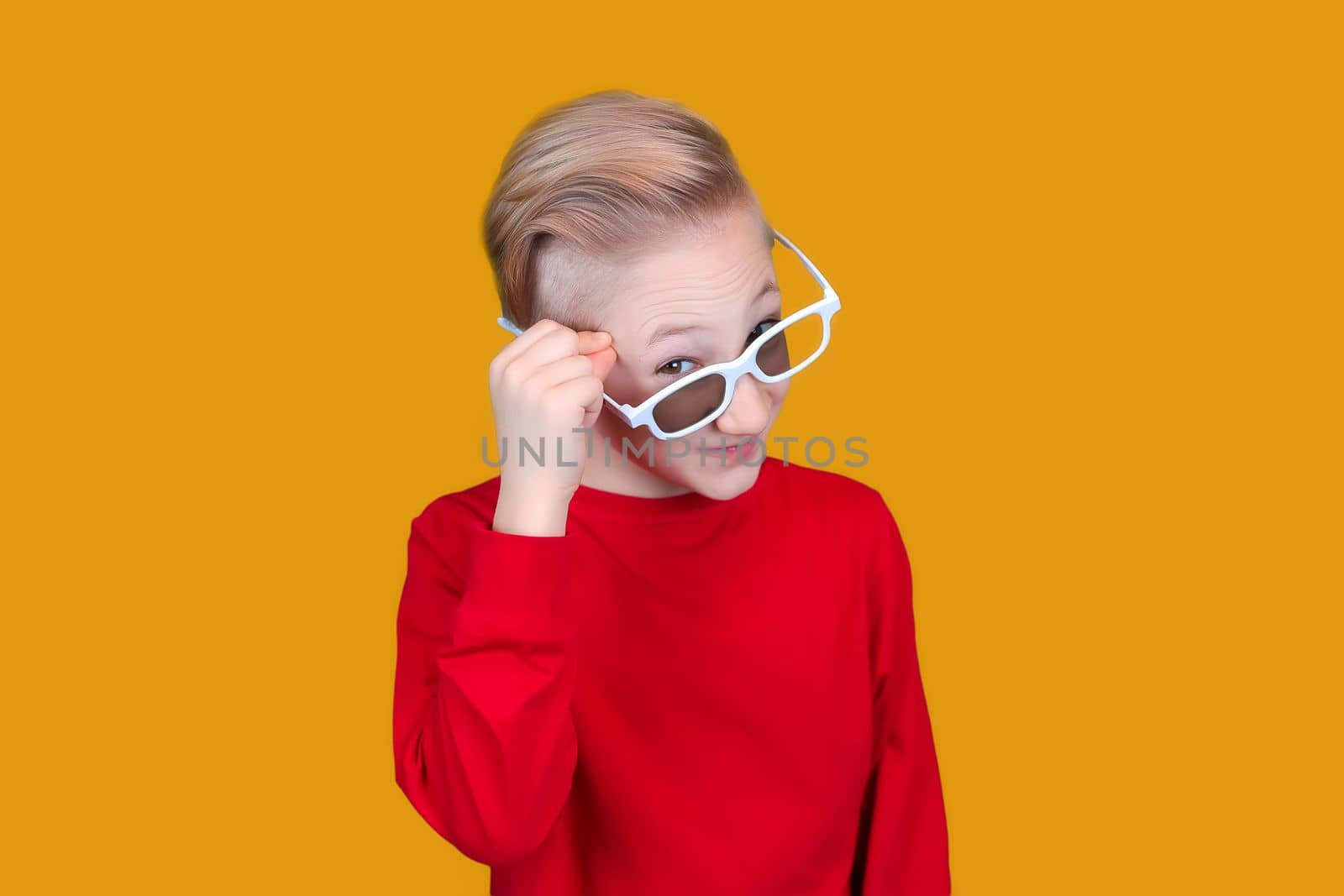 cool kid in red clothes and glasses showing emotions of surprise on a yellow background