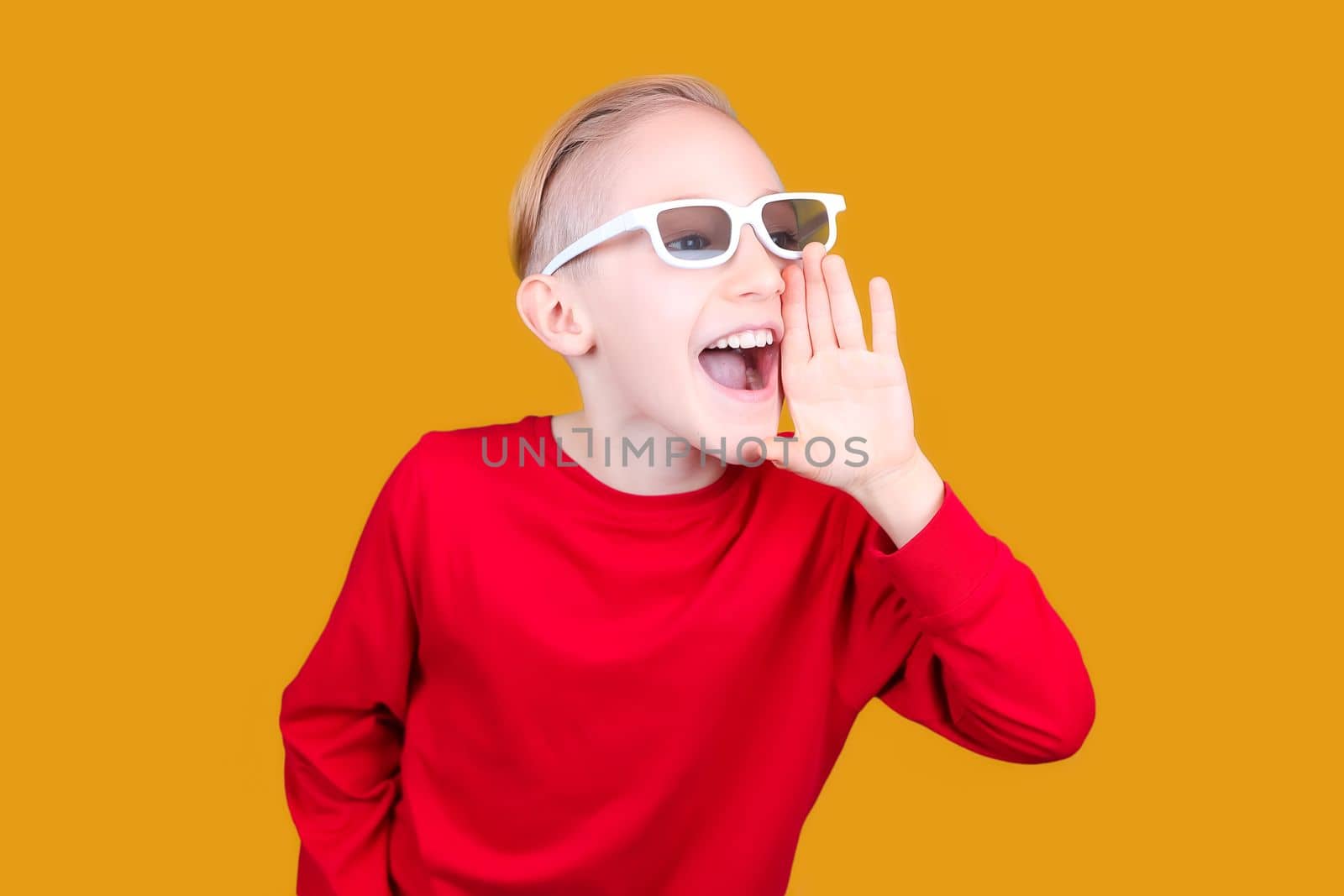 a child in 3D glasses puts his hand to his mouth and screams
