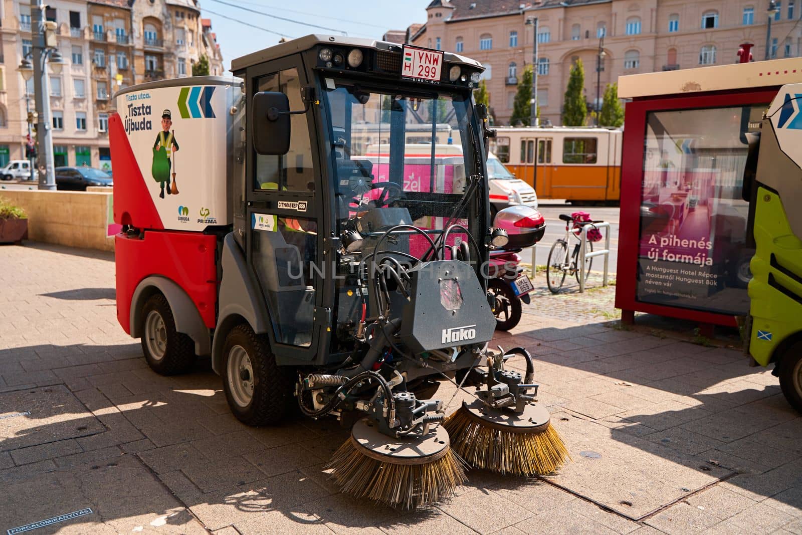 The vehicle washes the streets and cleans the pedestrian zone of the city. Budapest, Hungary - 08.25.2022