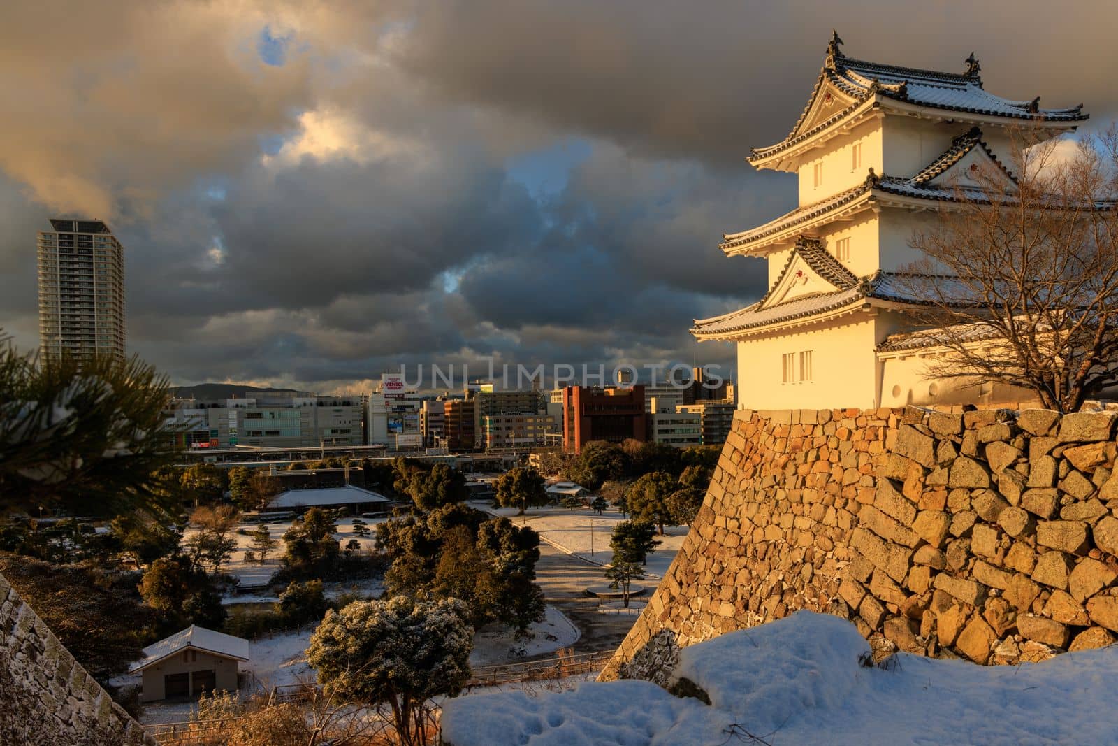 Akashi, Japan - January 25, 2023: Akashi Castle in morning sun on snowy winter day. High quality photo